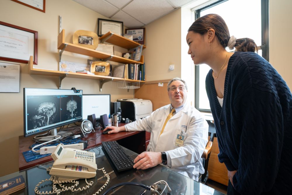 Doctor showing an intern brain scans